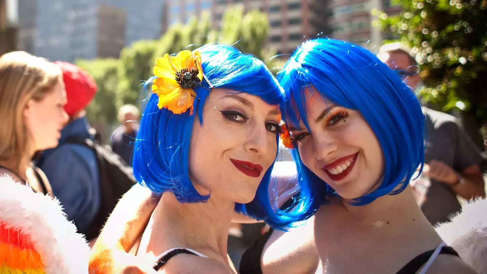 Two women sporting blue wigs attend San Francisco Pride.