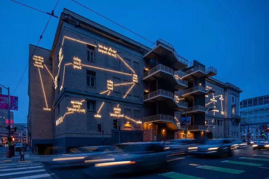 A building in San Francisco is illuminated with light art by artist Joseph Kosuth