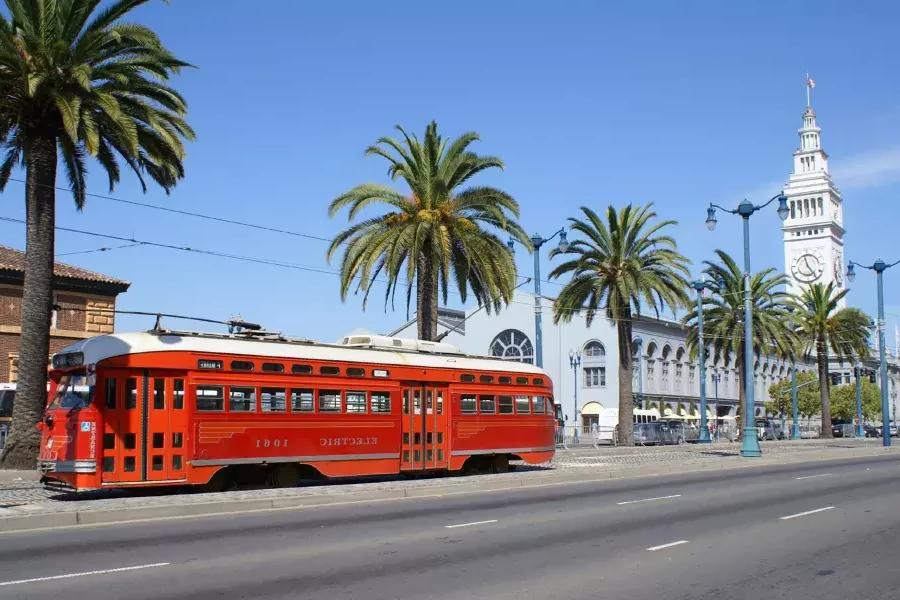 The F Line streetcar rolls down the Embarcadero in front of the Ferry Building.