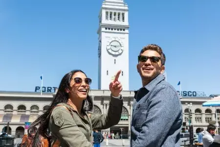 A visiting couple approach the San Francisco Ferry Building.